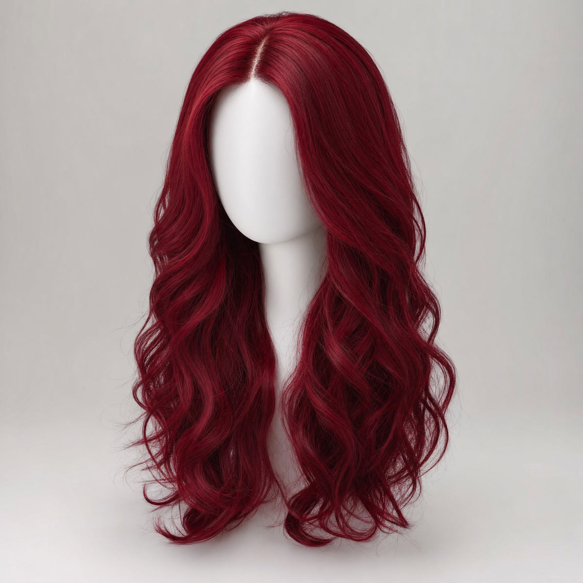 Long wavy deep crimson wig on a plain white mannequin head against a pale grey background