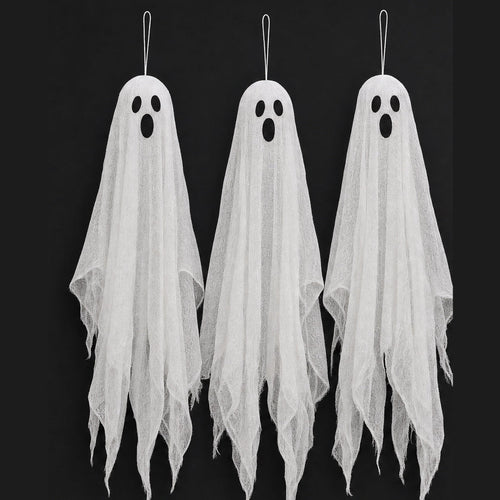 Three hanging gauze ghosts with dark oval eyes against a black background