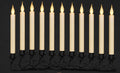 Row of ivory flameless taper candles with warm flickering LED flames on a black wire garland