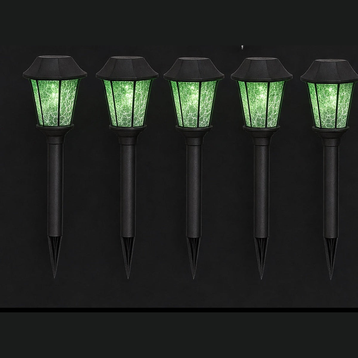 Five black garden stakes topped with lanterns glowing acid green in the dark
