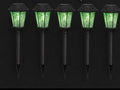 Five black garden stakes topped with lanterns glowing acid green in the dark